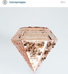 an unusual light fixture made out of cardboard