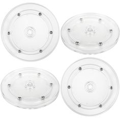 four clear plastic plates with holes in the middle