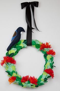 a paper wreath with flowers and a bird on it