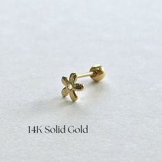 * Solid Gold * Anniversary Gift * Christmas Gift * Bridesmaids Gift * Wedding Gift * Birthday Gift Golden Daisy Cartilage Earring features a delicate daisy flower design, crafted from 14K solid gold. Its charming and playful style brings a touch of nature to your look, making it the perfect accessory for adding a hint of floral elegance to your everyday wear. ✦ DETAILS * 14K Yellow Solid Gold * Measures 4.8mm * High polish finish * Sold as a single piece * Secured with screwball back * Hypoaller Flower Piercing, Cartilage Earring, Solid Gold Jewelry, Classic Jewelry, Cartilage Earrings, Single Earring, Screw Back Earrings, Daisy Flower, Bridesmaid Gifts