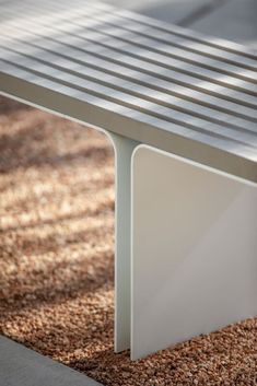 a metal bench sitting on top of a carpet covered ground