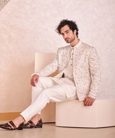 Editor's Note Featuring Kashmiri Jamawar Hand Embroidered Short Jacket. Paired With Short Kurta And Tapered Trousers. Fabric: Linen Silk Color: Ivory Component: Jacket, Kurta, Trousers Care: Dr... Tailored Cream Outerwear For Wedding, Cream Long Sleeve Nehru Jacket For Festive Occasions, Festive Beige Long Sleeve Bandhgala, Fall Wedding Nehru Jacket With Floral Embroidery, Fall Wedding Outerwear With Floral Embroidery, Tailored White Sets For Fall, Traditional Embroidered Outerwear For Work, White Long Sleeve Suits For Winter, White Nehru Jacket For Spring Formal