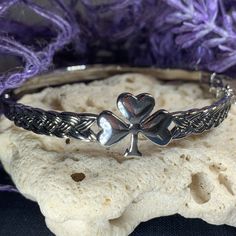 TAKE AN ADDITIONAL 20% OFF THE ALREADY REDUCED SALE PRICE - ADDITIONAL 20% IS DEDUCTED AT CHECKOUT with code SAVE20 Stunning and very lovely! Our "Faith abounds," Shamrock Celtic knot bangle pewter bracelet is a must have. It is embraced on both sides by approximately 5/8" of a braided Celtic knot work pattern which is defined by light antiquing. The remainder of the bangle is sleek and unadorned. 2 3/8" x 2 3/8" in size. A safety chain provides elegance and peace of mind! Rhodium over lead-free Shamrock Bracelet, Celtic Knot Work, Knot Bangle, Tree Of Life Jewelry, Clover Bracelet, Celtic Knot Ring, Work Pattern, Irish Jewelry, Gift Girlfriend