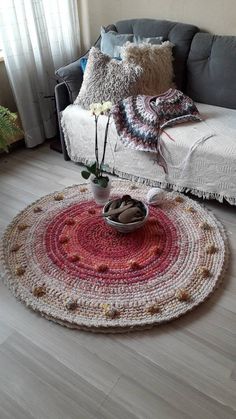 a living room with a couch and rug on the floor