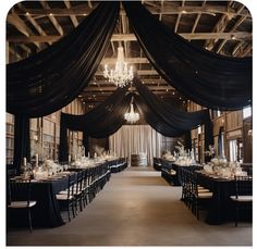 an elegant black and white wedding reception with chandelier