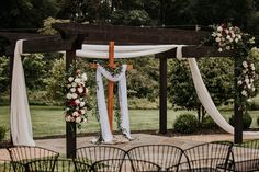 an outdoor wedding setup with white and red flowers