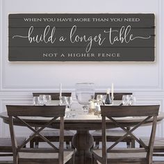 a wooden sign that says, when you have more than you need build a longer table not a higher fence