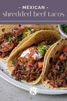 three mexican shredded beef tacos on a plate