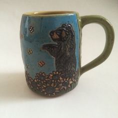 a ceramic mug with a bear on it