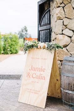 a wooden sign that says welcome to jamie and calia on the side of a building