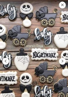 some decorated cookies are sitting on a wooden table with the words welcome little nightmare written in black and white