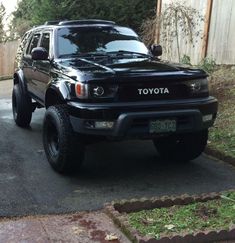 a black toyota truck is parked in the driveway