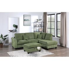 a living room with a large green sectional couch and footstool in front of a window