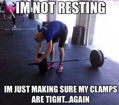 a man lifting a barbell in a gym with the caption i'm not resting im just making sure my lamps are tight again