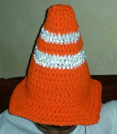 a child wearing an orange hat with silver sequins