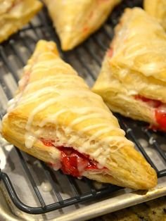 four pastries sitting on top of a cooling rack