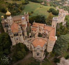 an aerial view of a castle in the middle of trees