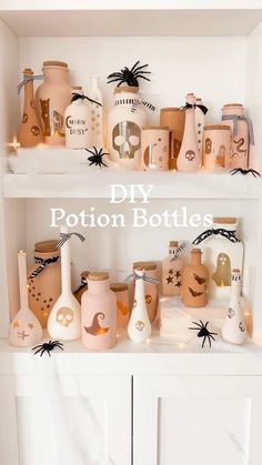 some bottles are sitting on top of a shelf with spider webs and candles in them