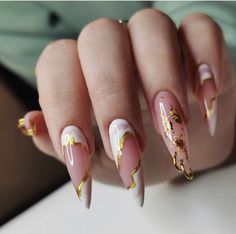 a woman's hand with pink and gold nails