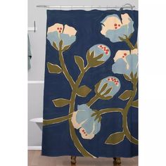 a blue shower curtain with white flowers on it