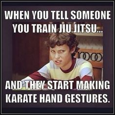 a young boy sitting at a table in front of a book with the caption when you tell someone you train jiu itsu and they start making karate hand gestures