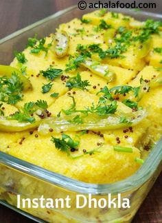 a casserole dish filled with yellow food and garnished with parsley