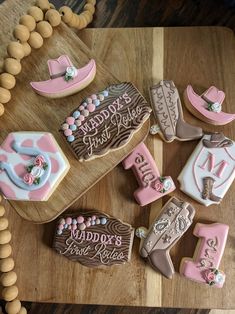 decorated cookies are arranged on a wooden table with letters and numbers in the shape of horseshoes