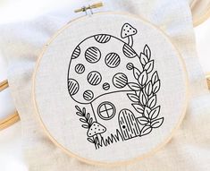 a cross stitch pattern with an image of a mushroom in the middle and plants around it