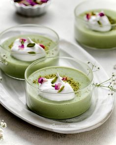 three small desserts on a white plate with the words faan blancmange