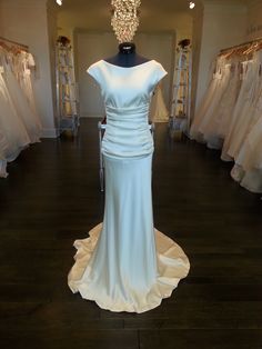 a wedding dress on display in a bridal shop