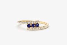 "Blue Sapphire Ring / 14k Solid Gold Cross Over Diamond Ring with Round Blue Sapphires / September Birthstone Ring by Ferkos Fine Jewelry *Made to Order *Gold Kt: 14K (also available in 18K) *Available Gold Color: Rose Gold, Yellow Gold, White Gold *Round Diamond: 32 pcs 1.0 MM *Round Sapphire: 3 pcs 2.0 MM *Diamond Carat Weight: 0.15 ctw *Sapphire Carat Weight: 0.15 ctw * Diamond Color-Clarity: G Color SI Clarity If you have any additional questions about this ring, just hit the \"Message Ferko Fine Jewelry Ring With Side Stones, Fine Jewelry Rings With Side Stones As Gift, Blue Round Cut Rings With Side Stones, Fine Jewelry With Side Stones As A Gift, Luxury Jewelry With Side Stones As Gift, Luxury Jewelry With Side Stones For Gift, Yellow Gold Sapphire Ring With Gemstone Accents, Yellow Gold Sapphire Ring With Gemstone Accents For Anniversary, Anniversary Yellow Gold Sapphire Ring With Gemstone Accents