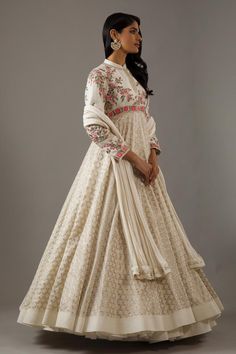 Ivory long sleeves mandarin collar neck flared anarkali with dahlia bloom flora and banasai jaal embroidery. Paired with churidar and seer sucker detail dupatta.
Components: 3
Pattern: Embroidery
Type Of Work: Dahlia Bloom Flora
Neckline: Mandarin Collar
Sleeve Type: Long
Fabric: Silk Chanderi, Lining: Cotton
Color: Ivory
Other Details: 
Note: The cancan skirt worn by the model is not for sale
Occasion: Sangeet, Mehendi and Haldi - Aza Fashions White Long Sleeve Dresses For Diwali, Embroidered Semi-stitched Long Sleeve Anarkali Set, Traditional White Gown For Transitional Seasons, Long Sleeve Gown With Floral Embroidery For Festivals, Anarkali Set With Floral Embroidery For Wedding, Cream Churidar With Intricate Embroidery, Elegant Embroidered Off White Anarkali Set, Anarkali Wedding Set With Floral Embroidery, Bollywood Style Floral Embroidered Long Sleeve Gown