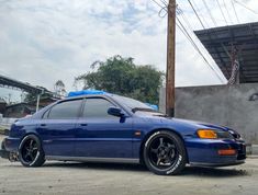 a blue car parked in front of a building