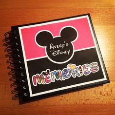 a notebook with the words disney and mickey mouse's head on it, next to an autograph book