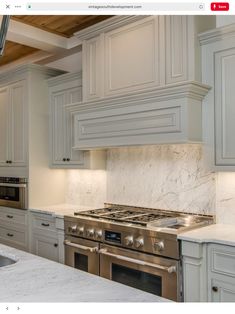 an image of a kitchen setting with marble counter tops and stainless steel stove top oven