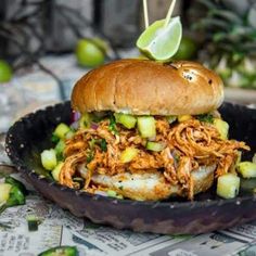 a pulled pork sandwich in a black bowl