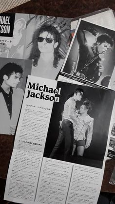 several photos of michael jackson are on the table next to some papers with pictures of them