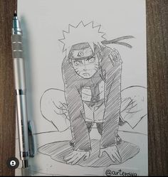 a drawing of naruto on paper next to a pen