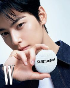 a man holding a white ball with the word christian dior on it