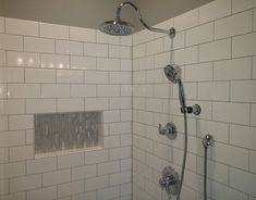 a shower head with thermostaer and faucet on it in a bathroom