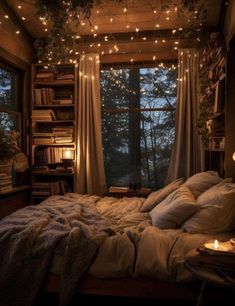 an unmade bed with lights strung from the ceiling and bookshelves above it