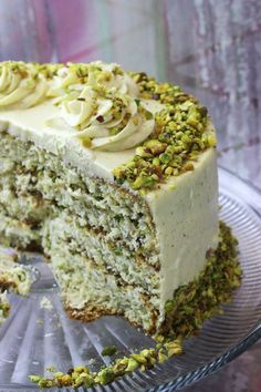 a slice of cake with white frosting and green sprinkles on top