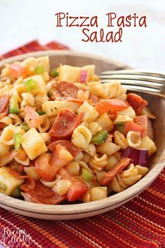 a pasta salad in a bowl with a fork on the side, ready to be eaten