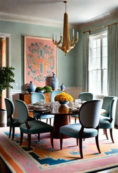 a dining room table with blue chairs and a chandelier