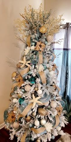 Aqua starfish Beach mermaids seahorse corral ribbon Christmas trees Beach Theme Christmas Tree Ideas, Beachy Christmas Decor, Beachy Christmas Tree, Beach Christmas Trees, Beach Christmas Decorations, Boho Christmas Tree, Beach Christmas Ornaments, Coastal Christmas Tree, Florida Christmas