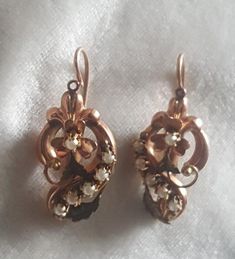 These earrings are a beautiful rose gold. They have been tested to gold of 14k.  They have a European touchmark on the ear backs but I cannot make them out. The earrings are ornate with a clover center,  swirls and textured leaves. Each earring has 6 claw set natural pearls. The thing to consider with these is that the earrings are mirror images of each other, something that looks a small touch but very labour intensive to do. These are masterfully done. C. 1880 and Continental 3.6 grams. Follow me on instagram@jettesjewels. Vintage 14k Gold Earrings With Intricate Design, Victorian Screw Back Earrings For Wedding, Victorian Screw Back Wedding Earrings, Victorian Wedding Earrings With Screw Back, Victorian Pierced Earrings For Anniversary, Victorian Pearl Earrings For Anniversary, Victorian Screw Back Earrings For Formal Occasions, Victorian Style Earrings For Anniversary, Ornate Hallmarked Rose Gold Jewelry