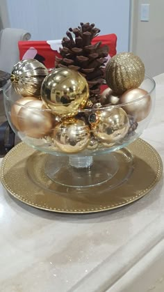 a glass bowl filled with ornaments on top of a counter