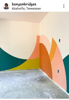 an empty room painted with colorful shapes