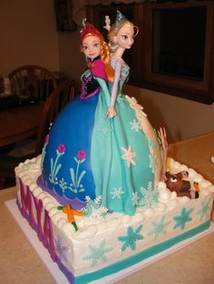 there is a cake that looks like the princess and the frog are on top of it