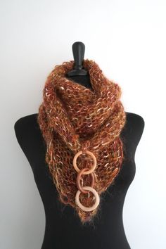 This elegant and sumptuous kerchief is a true fashion statement and is sure to draw attention. You can wear it in so many ways. Just look at the pictures to get some ideas. I knitted this mini shawl from a soft mohair acrylic yarn and embellished with wooden rings. More scarves - https://www.etsy.com/shop/KnitsomeStudio?section_id=6751131 More shawls - https://www.etsy.com/shop/KnitsomeStudio?section_id=6598836 Don't forget to check out my other items! There are many more in my shop -- https://w Brown Shawl Scarf One Size, Brown Bohemian Scarves One Size, Handmade Elegant Scarves One Size, Brown Shawl Scarf, Brown Winter Scarves For Gifts, Brown Winter Scarves For Gift, Handmade Brown Shawl Scarf, Handmade Brown Scarves For Gifts, One-size Brown Shawl